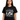 Woman wearing Genesis Lamb Lies Down Tour T-Shirt featuring artistic design from the 1974 North American Tour.