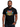 Man wearing Earth Wind & Fire Fantasy T-shirt featuring colorful graphic design on black fabric.