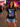 Woman wearing a Megadeth Rust in Peace T-Shirt with concert atmosphere in the background.