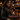 Man in a leather jacket sitting at a bar with an Iron Maiden wallet on a table.