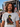 Man wearing Jimi Hendrix Sunset Grey T-Shirt at a music festival with a crowd in the background.