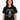 Metallica Scary Bones Black T-Shirt worn by a woman, featuring the iconic Scary Bones logo on a black background.