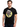 Man wearing a black Judas Priest Vengeance Anniversary T-Shirt featuring album cover art.