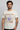 Model wearing Woodstock Wild Flowers Natural T-Shirt featuring floral design inspired by Woodstock festival.